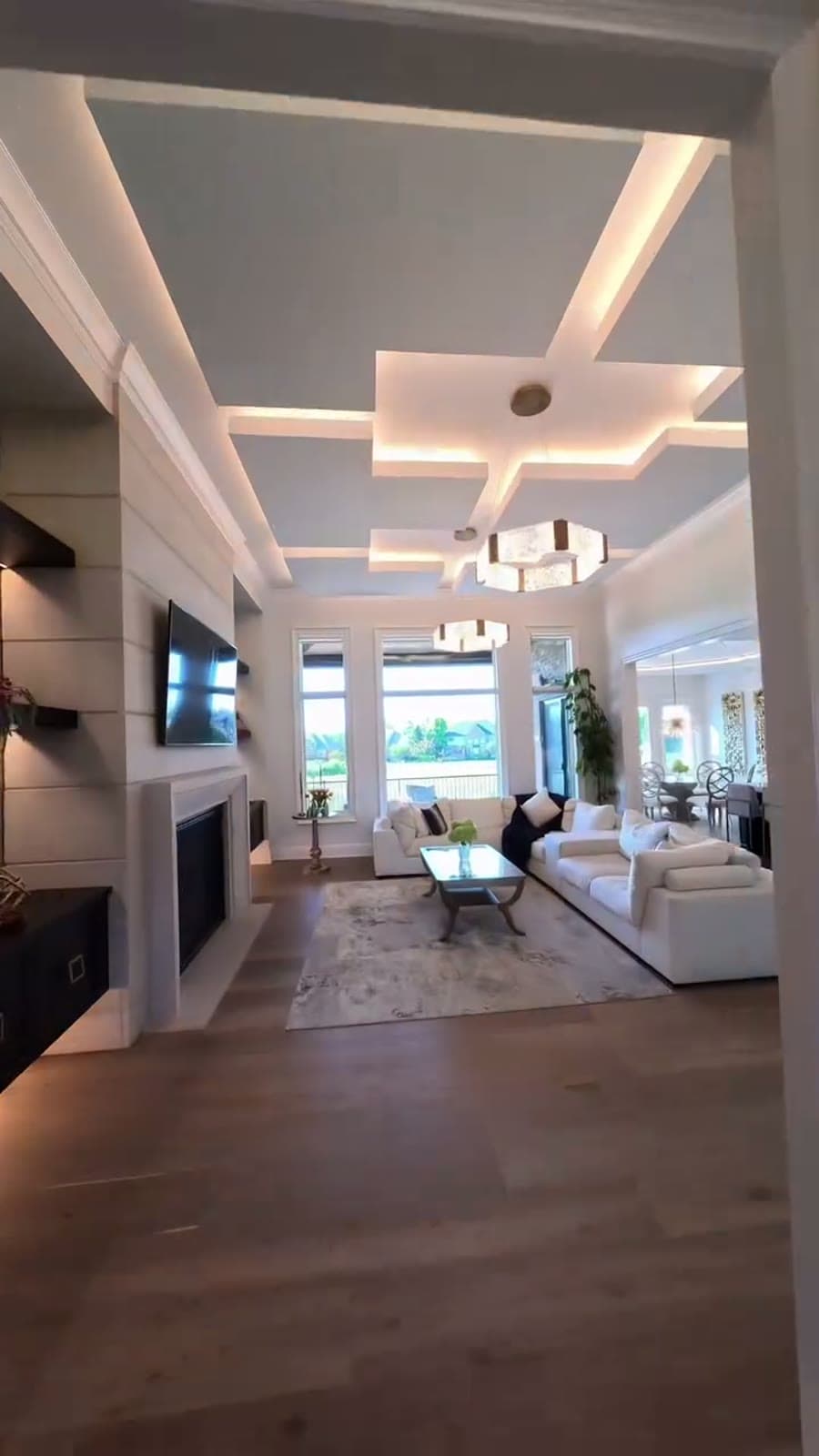 Great room with coffered ceiling and floor-to-ceiling windows